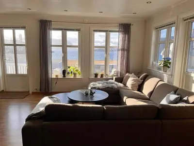 a living room with a couch and a table at Cozy house with sea view close to Ålesund in Havsteinen