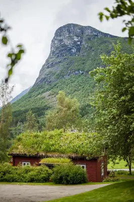 a house with a mountain in the background at Vårsetra in Bø