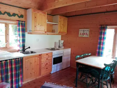 a kitchen with a table and a stove top oven at Vårsetra in Bø