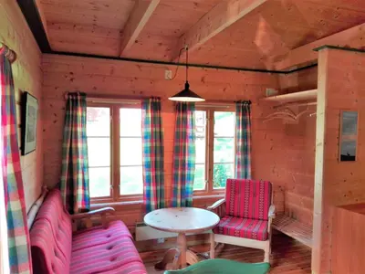 a room with a table and two chairs and a table at Vårsetra in Bø