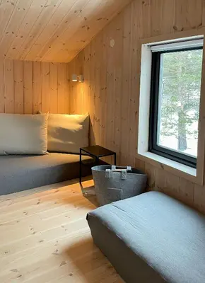 a bedroom with two beds and a window at Cozy Cabin At The Gateway To Jotunheimen in Vaga