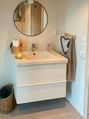 a bathroom with a sink and a mirror at Cozy Cabin At The Gateway To Jotunheimen in Vaga