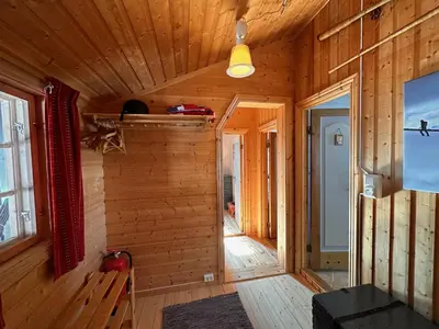 a room with a wooden wall in a house at A Peaceful Mountain Retreat in Beitostøl