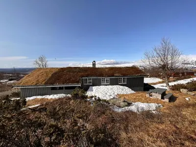 a house with a grass roof on top of a hill at A Peaceful Mountain Retreat in Beitostøl
