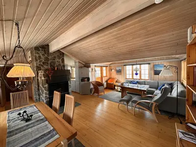 a living room with a couch and a table at A Peaceful Mountain Retreat in Beitostøl