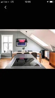 a kitchen and dining room with a table and chairs at Penthouse Ålesund city center in Ålesund
