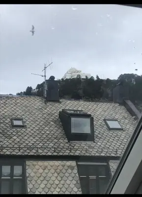 a roof with three windows on top of it at Penthouse Ålesund city center in Ålesund