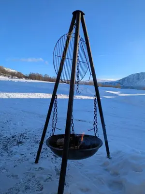 a tire swing on a beach in the snow at Three bedroom home with an amazing mountain view! in Oppdal