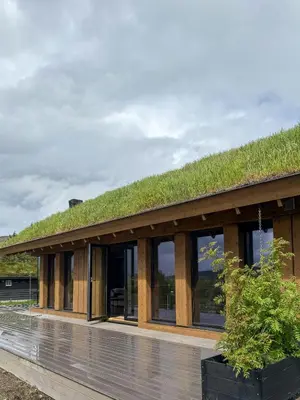 a building with a grass roof with windows at Modern Cabin With Panoramic Views In Stryn in Stryn