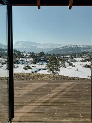 a view of a snow covered field from a window at Modern Cabin With Panoramic Views In Stryn in Stryn