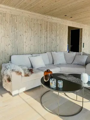 a living room with a couch and a table at Modern Cabin With Panoramic Views In Stryn in Stryn