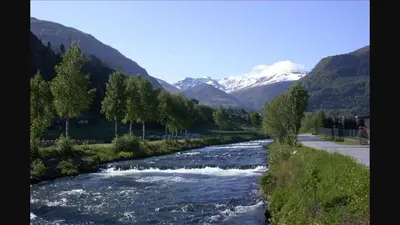a river with mountains in the background at Sognefjorden-Vik i Sogn in Brekka