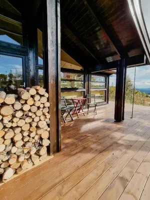 a room with a pile of logs on a deck at Bright Cabin In Eggedals Beautiful Mountains in Eggedal