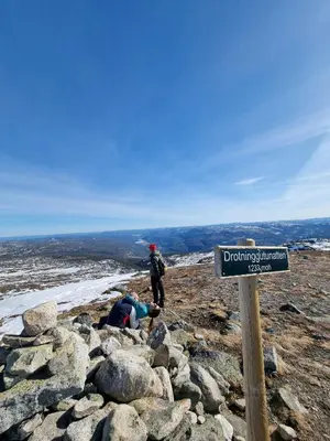 a man standing on top of a mountain with a sign at Bright Cabin In Eggedals Beautiful Mountains in Eggedal