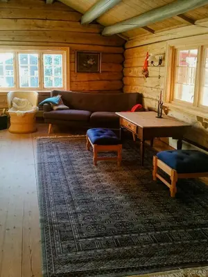 a living room with a couch and a table at Historic Log Cabin By Rondane National Park in Lårgard