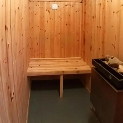 a wooden bench in a room with a stove at Historic Log Cabin By Rondane National Park in Lårgard