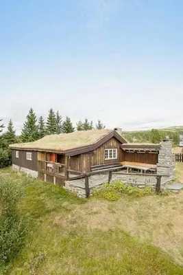a large wooden building with a grass roof at Historic Log Cabin By Rondane National Park in Lårgard