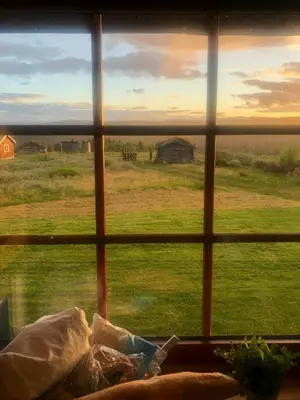 a view of a field from a window with a view at Historic Log Cabin With Views Of Rondane in Ringebu