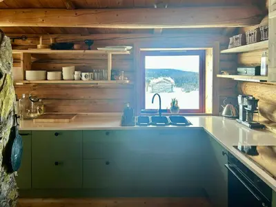 a kitchen with a sink and a window at Historic Log Cabin With Views Of Rondane in Ringebu