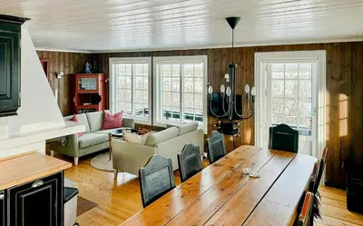 a living room with a wooden table and a couch at Upgraded Family Cabin At Sangefjell in Ål