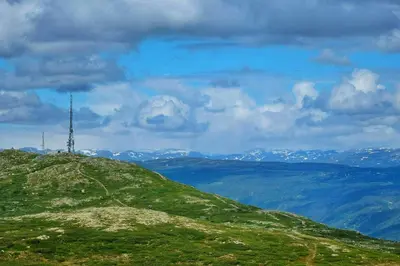 a grassy hill with a cell phone tower on it at Upgraded Family Cabin At Sangefjell in Ål