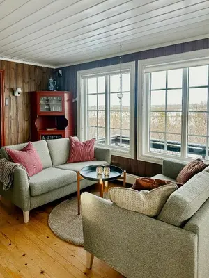 a living room with two couches and a table at Upgraded Family Cabin At Sangefjell in Ål
