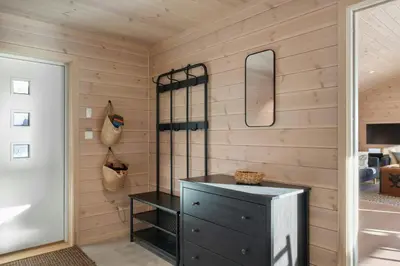 a bathroom with a black dresser and a mirror at Modern Mountain Cabin Near Norefjell in Eggedal