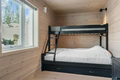 a bunk bed in a room with a window at Modern Mountain Cabin Near Norefjell in Eggedal