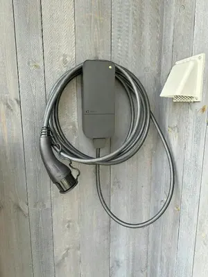 a wire hooked up to a charger on a wall at Modern Mountain Cabin Near Norefjell in Eggedal