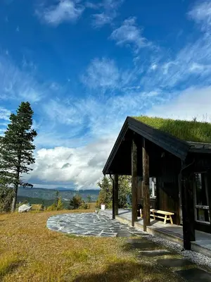 a building with a picnic table and a bench at Modern Cabin With Panoramic Views At Nesfjellet in Nesbyen
