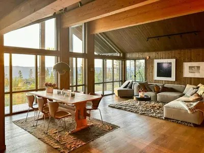 a living room with a table and a couch at Modern Cabin With Panoramic Views At Nesfjellet in Nesbyen