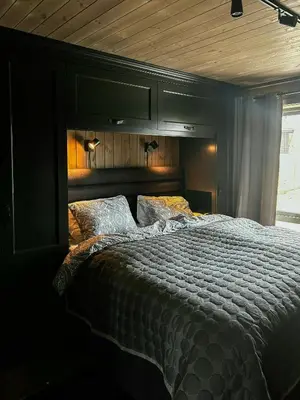 a bedroom with a large bed with a wooden ceiling at Modern Cabin With Panoramic Views At Nesfjellet in Nesbyen