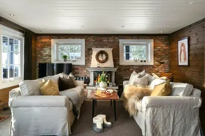 a living room with two couches and a fireplace at Family Cabin With Shelter By Lake Gautetjern in Gol