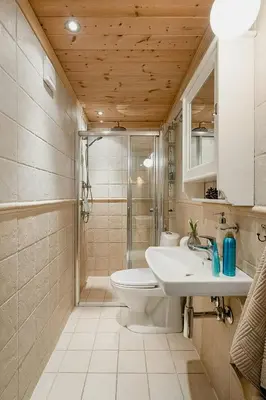 a bathroom with a toilet and a sink and a shower at Family Cabin With Shelter By Lake Gautetjern in Gol