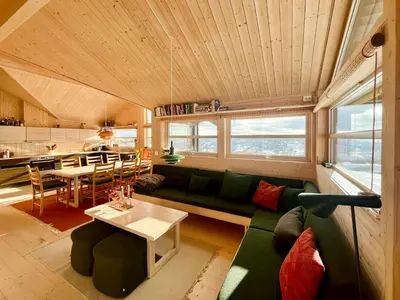 a living room with a green couch and a table at Architectural Gem With Views Of Hallingskarvet in Ål