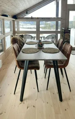 a dining room table with chairs and a tableasteryasteryasteryasteryasteryasteryastery at Cabin With A View And Close To Jotunheimen in Heggenes