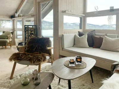 a living room with a couch and a table at Cabin With A View And Close To Jotunheimen in Heggenes