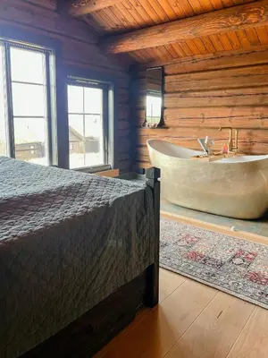 a bedroom with a bed and a bath tub at Log Cabin With Views Over Turufjell in Flå