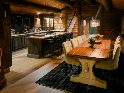 a kitchen with a wooden table in a cabin at Log Cabin With Views Over Turufjell in Flå