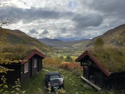 a truck parked in front of a cabin at Traditional Hemsedal family cabin spectacular view in Hemsedal
