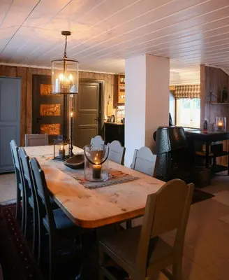 a dining room with a wooden table and chairs at Charming Cabin In Vikerfjell in Hønefoss