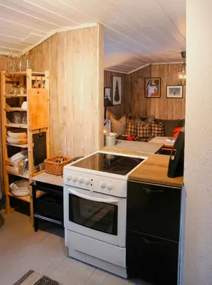 a kitchen with a stove and a counter top at Charming Cabin In Vikerfjell in Hønefoss
