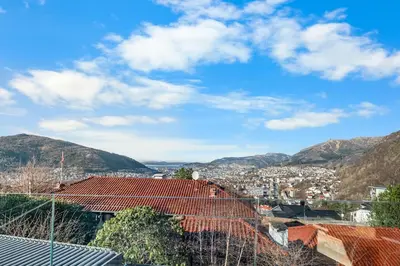 a view of a city with mountains in the background at Stay in The Hollywood Hills of Bergen with Breathtaking Views in Bergen