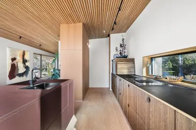 a kitchen with two sinks and a wooden ceiling at Stay in The Hollywood Hills of Bergen with Breathtaking Views in Bergen