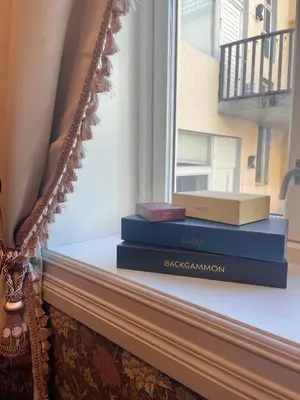two books sitting on a window sill next to a mirror at Jugend 1904 in Ålesund