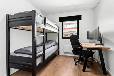 a room with a desk and a computer and bunk beds at Top-Floor Lakefront Apartment near Ski Resort in Hafslo