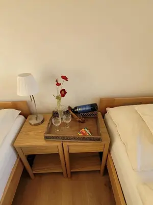 a table with glasses and a lamp on a bed at Adventure house Katrine in Mosvik