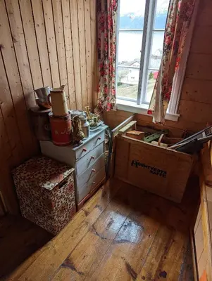 a room with a wooden floor and a window at The queen path right from the house in Tveit