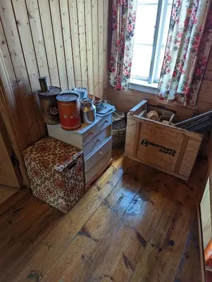 a room with a stove and a box and a window at The queen path right from the house in Tveit