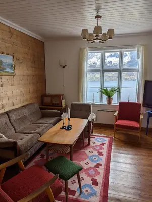 a living room with a couch and a table at The queen path right from the house in Tveit